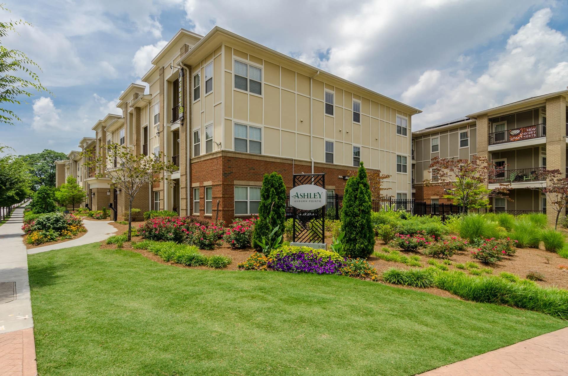 Community Corner Entrance Community entrance with corner building and manicured lawn at Ashley Auburn Pointe in Atlanta, GA